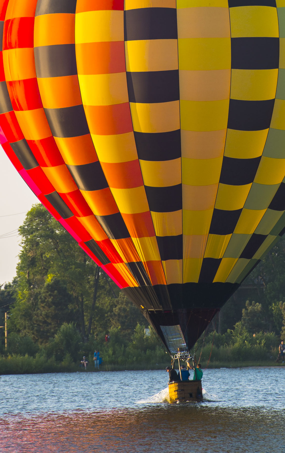 A balloon touches the surface of Prospect Lake Saturday, Sept. 2, 2017, during the Colorado Springs Labor Day Lift Off in Memorial Park. The balloon festival runs through Monday morning. (The Gazette, Christian Murdock)