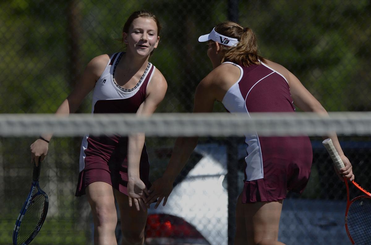 Ally Arenson, left, and Casey Ahrendsen celebrate after scoring a point against Niwot's Lauren Richards and Maura Derr during the No. 1 doubles finals Saturday, May 10, 2014, at the Colorado 4A girls state tennis championships finals at City Park in Pueblo. The Cheyenne Mountain team took the state title with a 6-4, 6-3 win. (The Gazette, Christian Murdock)