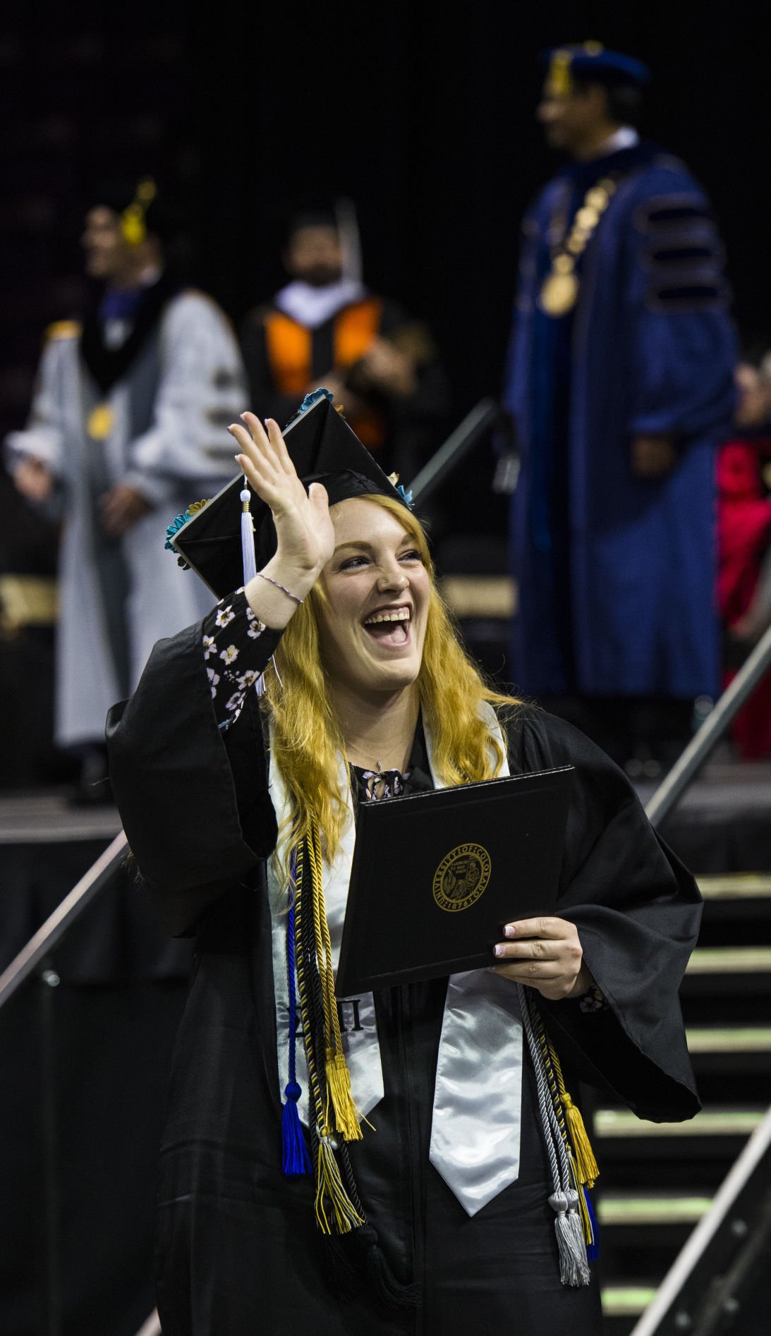 Katelyn Huddleston waves to her family after receiving her diploma during the University of Colorado at Colorado Springs' morning commencement ceremonies Friday, May 12, 2017, at the Broadmoor World Arena in Colorado Springs. A record 1,532 students received their degrees this Spring. (The Gazette, Christian Murdock)