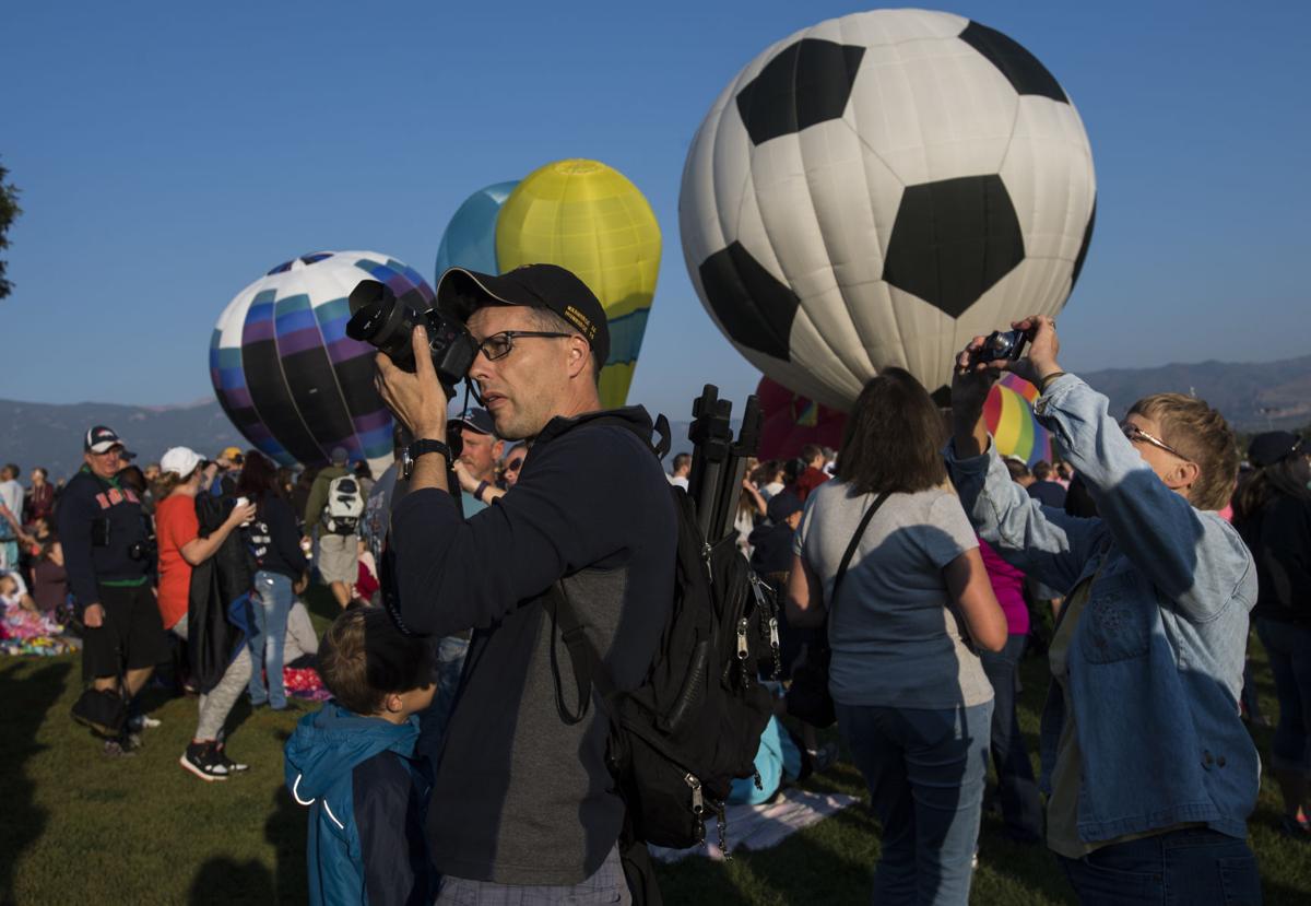 David Kaley of Colorado Springs photographs the balloons as the second wave takes off Saturday, Sept. 2, 2017, during the Colorado Springs Labor Day Lift Off in Memorial Park. The balloon festival runs through Monday morning. (The Gazette, Christian Murdock)