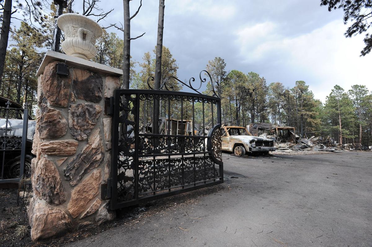 On Hardin Rd., a wrot iron and stone gate withstood the fire, but not the home behind the gate. Homeowners that are north of Burgess Rd. and east of Vollmer Rd. in the Black Forest burn area were able to return to their homes today on Tuesday, June 18, 2013.(Jerilee Bennett/The Gazette)