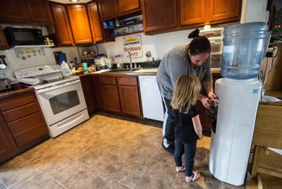 Bridgette Swaney and her daughter, Addison, 4, use the last of their bottled water to make mint tea at their Widefield home Thursday, Oct. 6, 2016. High levels of perfluorinated compounds, believed to be from a firefighting foam used at Peterson Air For...