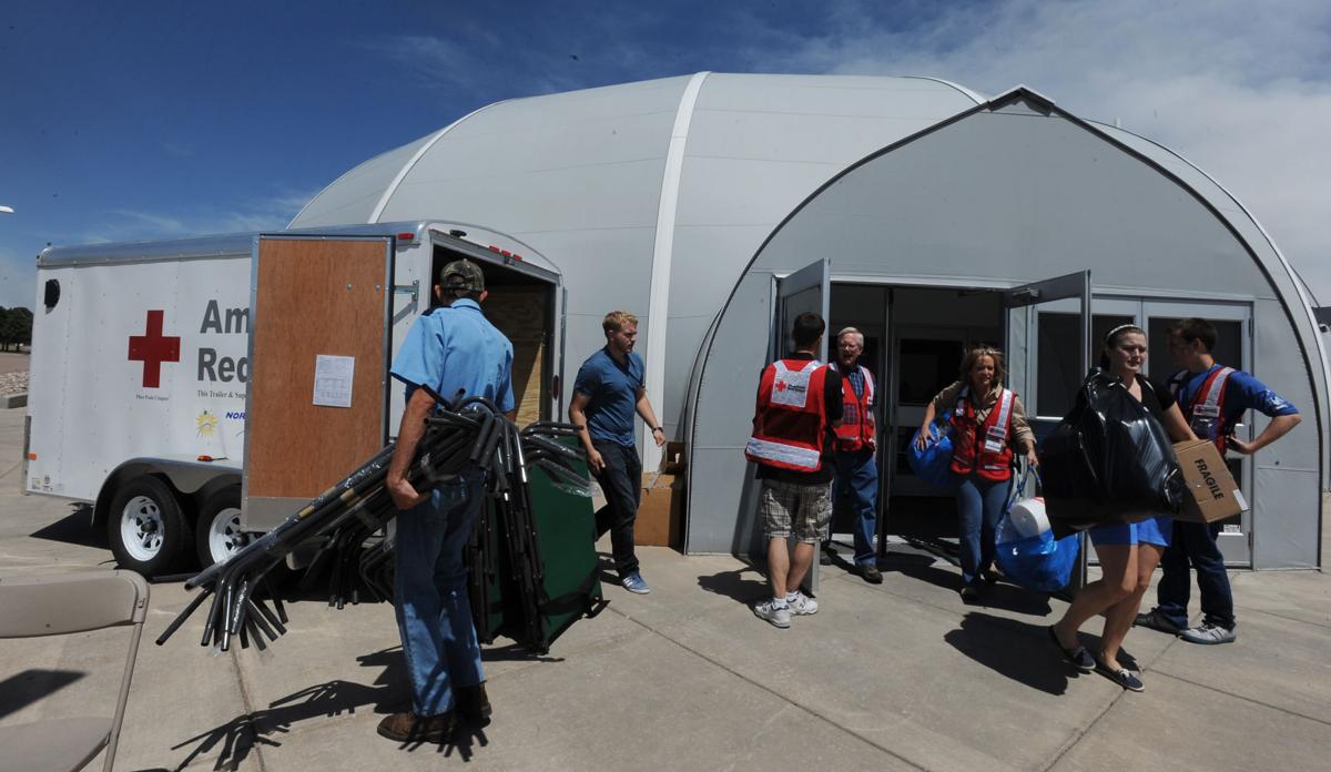 Red Cross workers and volunteers move provisions and cots from New Life Church after the evacuation center was moved to Palmer Ridge High School on Wednesday, June 12, 2013 during the second day of the Black Forest Fire in Colorado Springs, Colorado. (Jerilee Bennett/The Gazette)