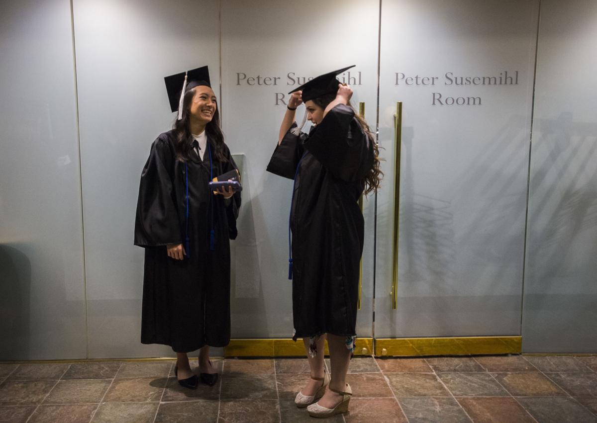 Biology majors Tam Nguyen, left, and Brittany Lydon get ready before the University of Colorado at Colorado Springs' morning commencement ceremonies Friday, May 12, 2017, at the Broadmoor World Arena in Colorado Springs. A record 1,532 students received their degrees this Spring. (The Gazette, Christian Murdock)