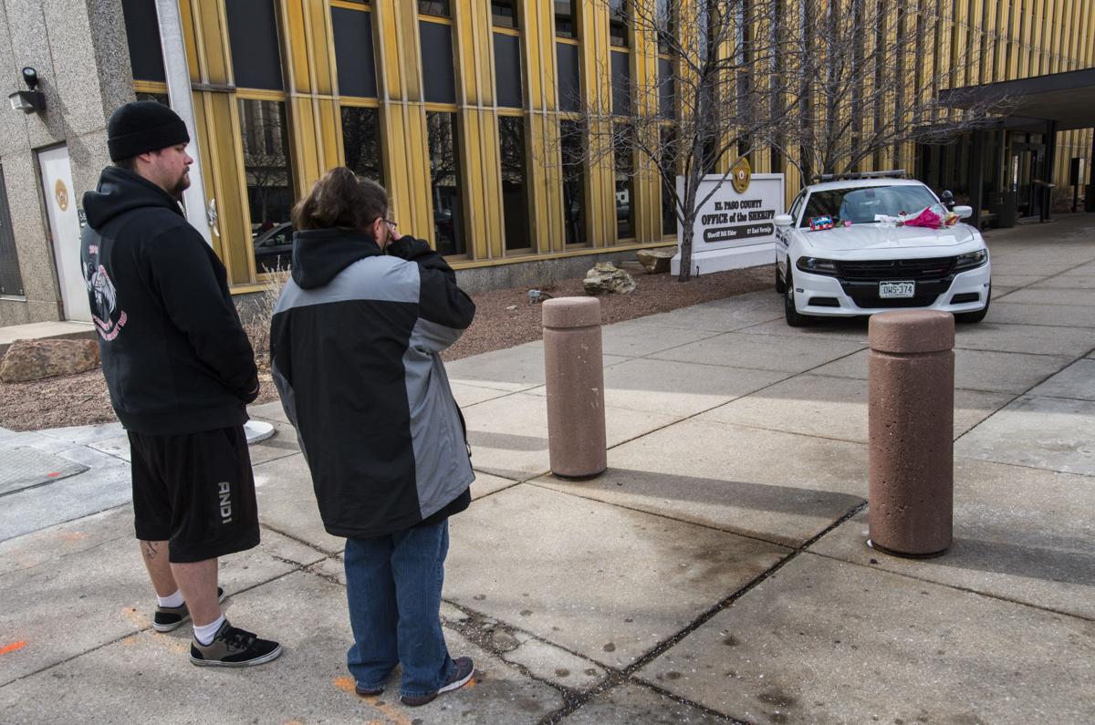 Karla Gross of Colorado Springs wipes away a tear as she and Joseph Gatelein pays their respects at the memorial outside the El Paso County Sheriffâs Office in Colorado Springs, Colo., Tuesday, Feb. 6, 2018, for deputy Micah Flick who was killed when an investigation of a motor vehicle theft turned into a deadly shooting Monday outside a Colorado Springs apartment complex. Three other law enforcement officers were shot. The suspect was killed and one citizen injured. Gross and Gatelein didnât know the 34-year-old deputy but wanted to pay their respects. (The Gazette, Christian Murdock)