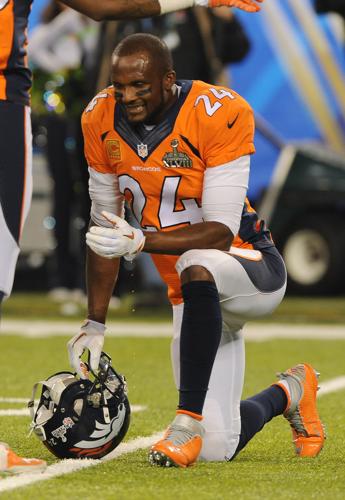 Denver's cornerback Champ Bailey kneels and grimaces in between plays  during the first quarter of the