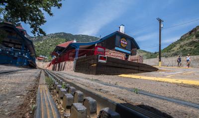 Tourists walk past the closed depot Tuesday, June 12, 2018, at The Pikes Peak Cog Railroad in Manitou Springs. After 126 year of operation the train to the summit of Pikes Peak didnât open for the summer because of needed repairs to the trains and tra...