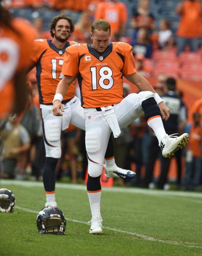Peyton Manning of the Denver Broncos warms up prior to playing in