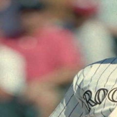Dante Bichette of the Colorado Rockies looking on holding a bat