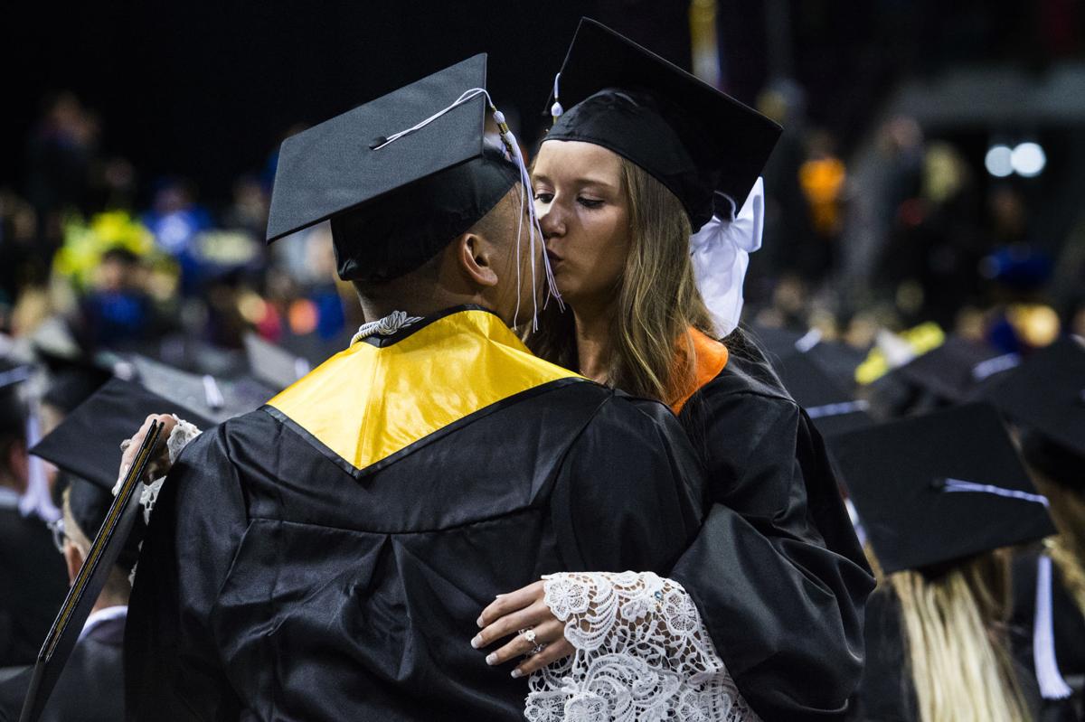 Micaela Scapin kisses her boyfriend, David Duarte, after they received their diplomas during the University of Colorado at Colorado Springs' morning commencement ceremonies Friday, May 12, 2017, at the Broadmoor World Arena in Colorado Springs. The couple met each other their freshman year at UCCS. A record 1,532 students received their degrees this Spring. (The Gazette, Christian Murdock)