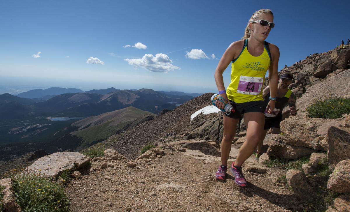 Emily Fischer of Colorado Springs nears the finish of 2015 Pikes Peak Ascent Saturday, Aug. 15, 2015, on the top of 14,115-foot Pikes Peak. The 13.2-mile race begins in Manitou Springs, Colo., and follows Barr Trail to the top of the mountain. (AP Photo/The Gazette, Christian Murdock)