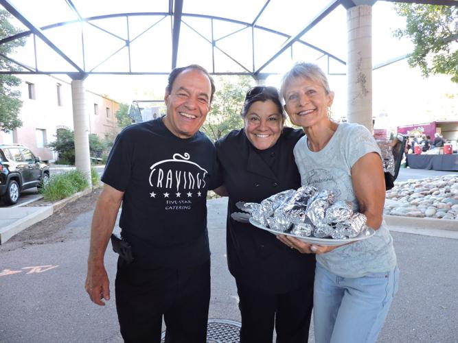 The Talaricos load up a platter of breakfast burritos for volunteer Elizabeth Youngquist to deliver to a table at Off the Street. 072017 Photo by Linda Navarro