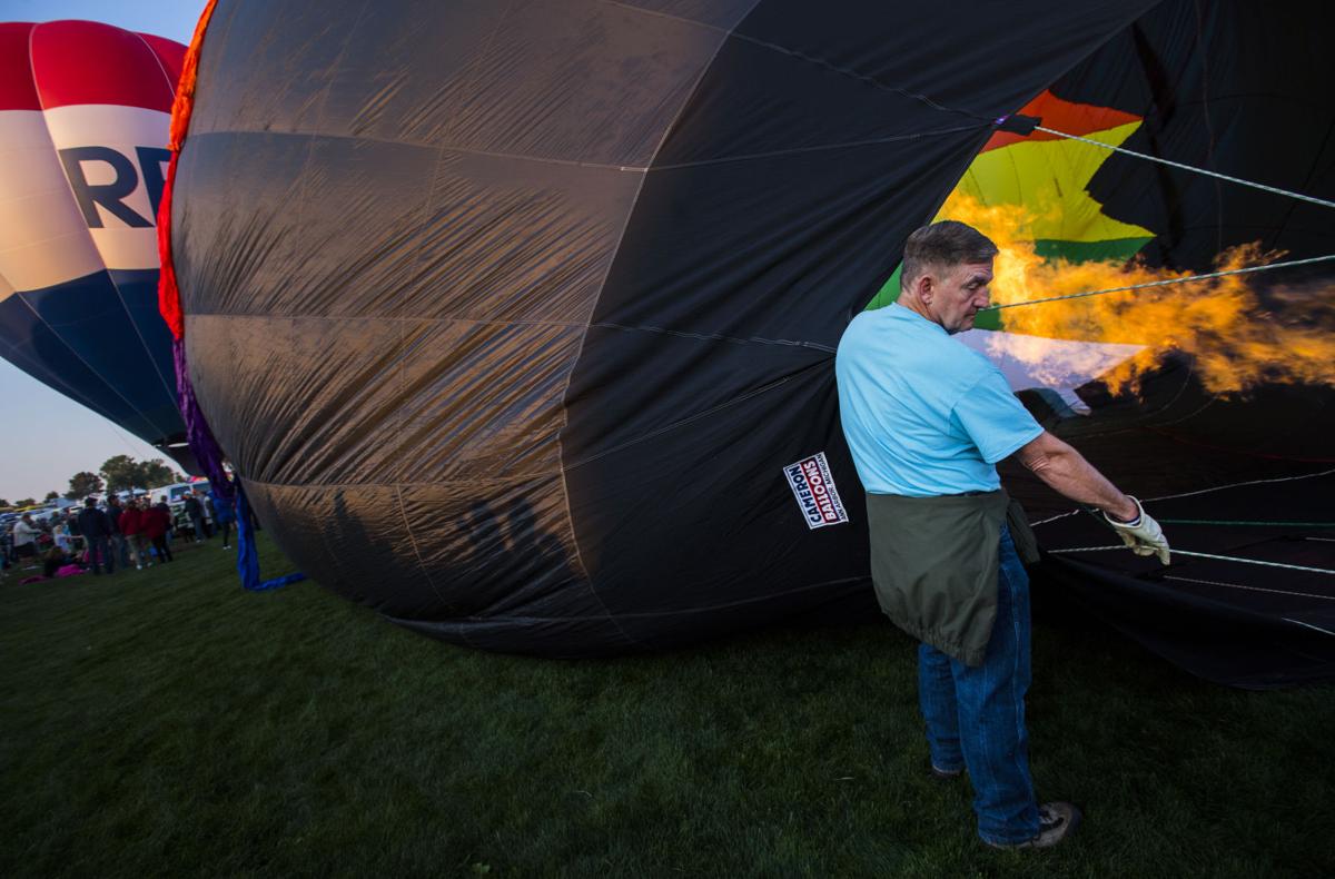 Bruce Amos helps fill the Incognito balloon Saturday, Sept. 2, 2017, during the Colorado Springs Labor Day Lift Off in Memorial Park. The balloon festival runs through Monday morning. (The Gazette, Christian Murdock)