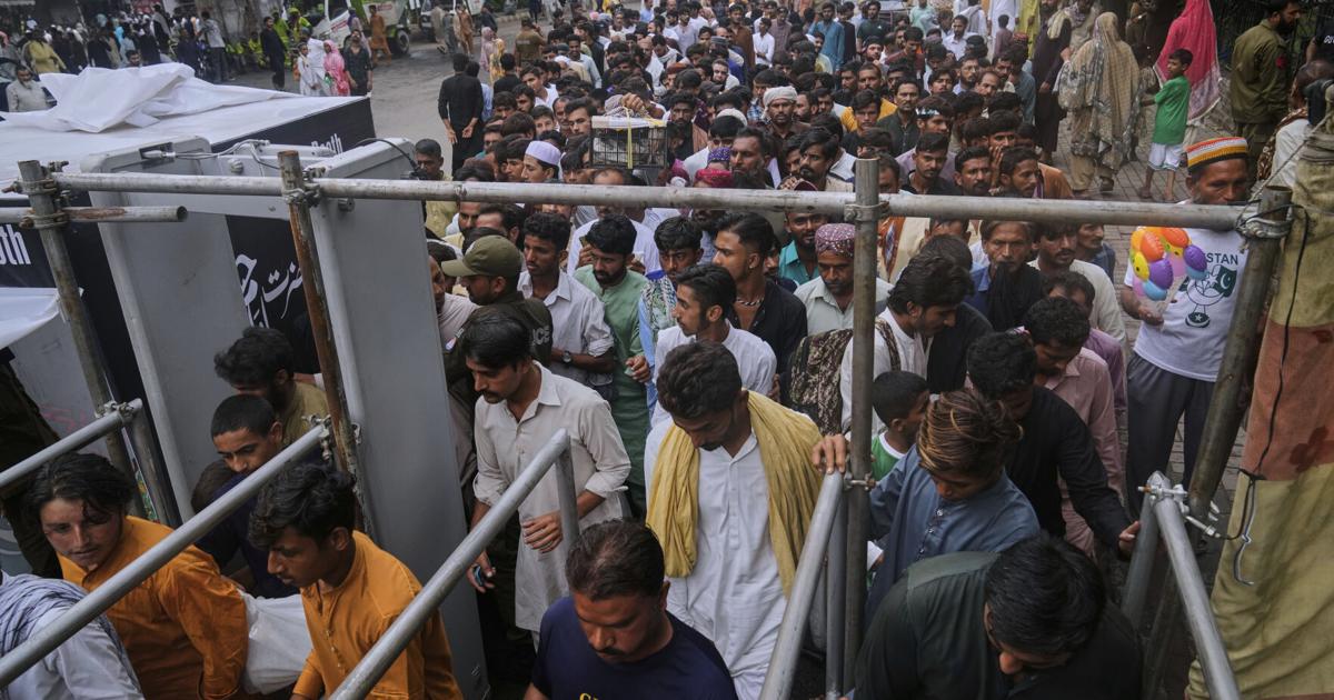 Photos of Pakistan honoring a Sufi saint with drumming, dancing, and bright lights
