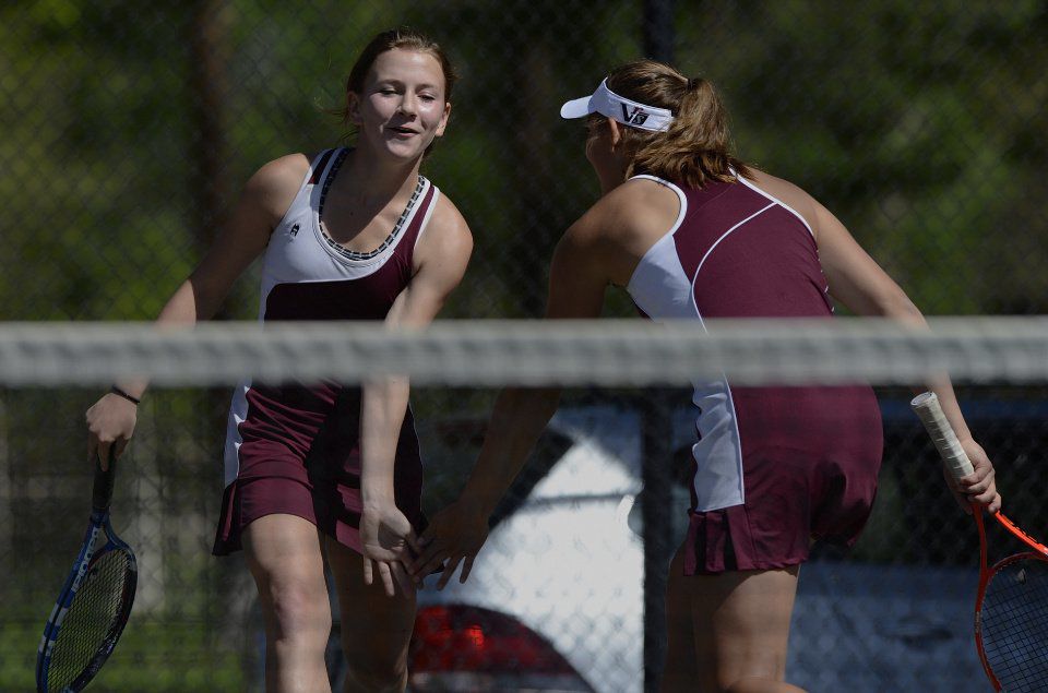 Ally Arenson, left, and Casey Ahrendsen celebrate after scoring a point against Niwot's Lauren Richards and Maura Derr during the No. 1 doubles finals Saturday, May 10, 2014, at the Colorado 4A girls state tennis championships finals at City Park in Pueblo. The Cheyenne Mountain team took the state title with a 6-4, 6-3 win. (The Gazette, Christian Murdock)