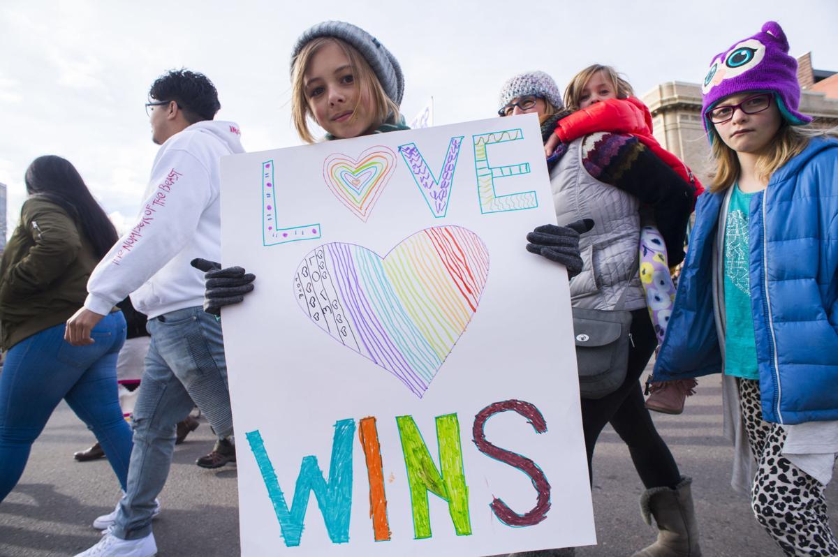A young protester carries a sign as she marches down Tejon Street Saturday, Jan. 21, 2017, during the Colorado Springs Women's March in downtown Colorado Springs. The sister march of the Women's March on Washington, D.C., drew between 5,000 and 10,000 people. (The Gazette, Christian Murdock)