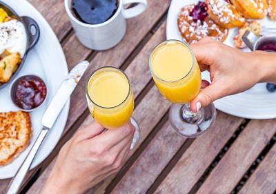 Mimosa Cheers A toast with mimosas. Photo Credit: Eric Marion Williams (iStock).