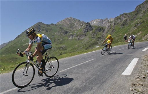 American seven-time Tour de France winner Lance Armstrong, left, and Rinaldo Nocentini of Italy, wearing the overall leader's yellow jersey, right, speed down Tourmalet pass during the 9th stage of the Tour de France cycling race over 160.5 kilometers (10