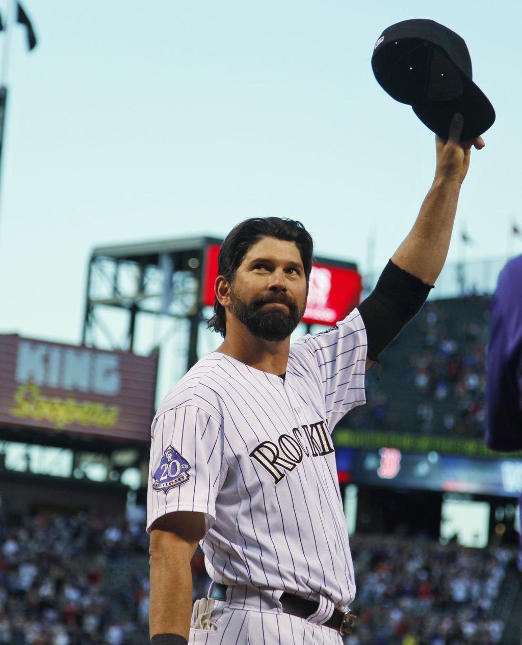 From left, retired Colorado Rockies first baseman Todd Helton is joined by  his daughter Gentry Grace, wife Christy and oldest daughter Tierney Faith  during a ceremony at which the player's number was