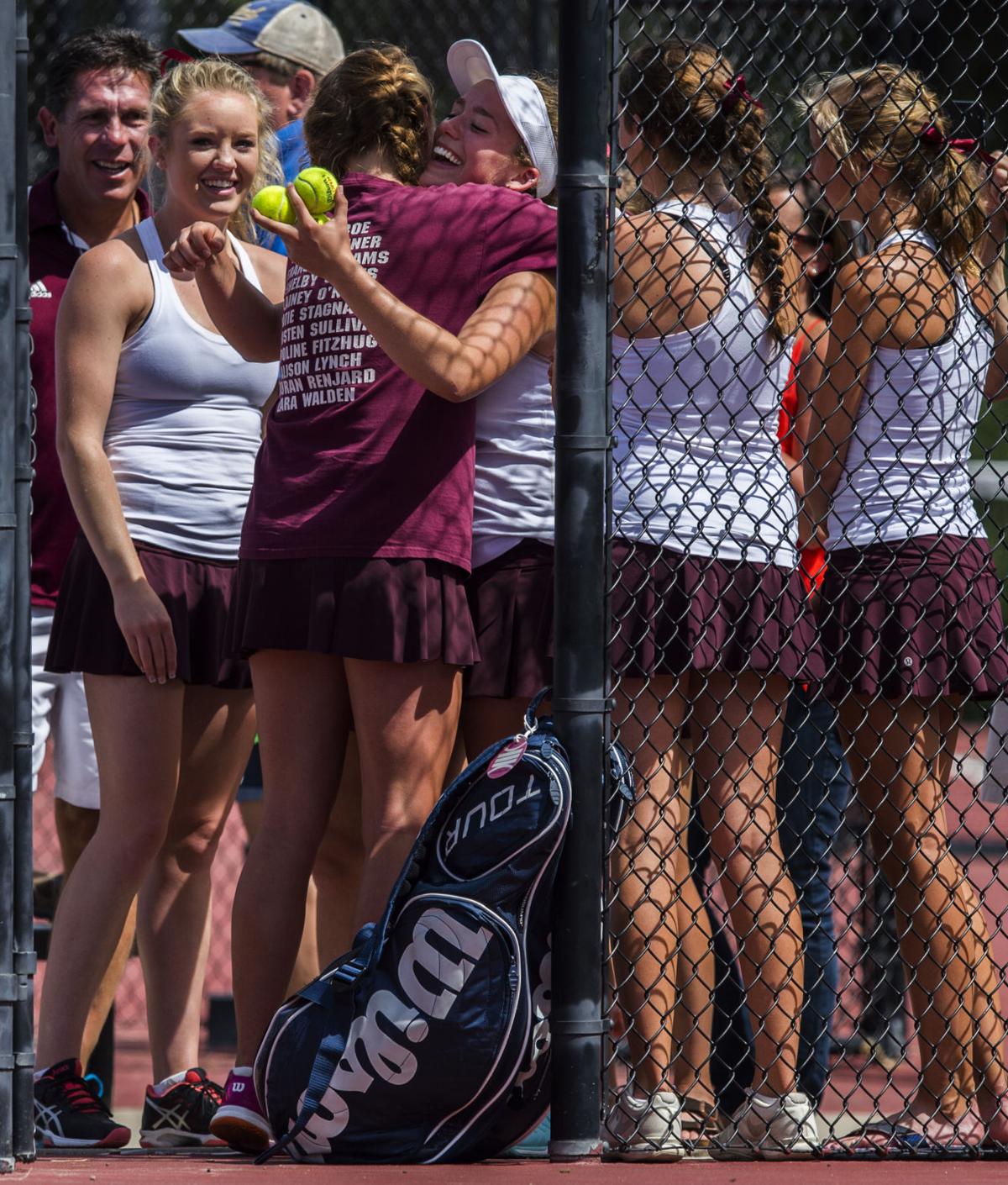 Cheyenne Mountain’s Claire Dibble, holding tennis balls, receives a hug from teammate Taylor Heinicke after Dibble won the No. 3 Singles finals against Valor Christian’s Isabella Pacheco Saturday, May 13, 2017, at the 4A State Tennis Championships in Pueblo. Dibble won 7-5, 6-4. (The Gazette, Christian Murdock)