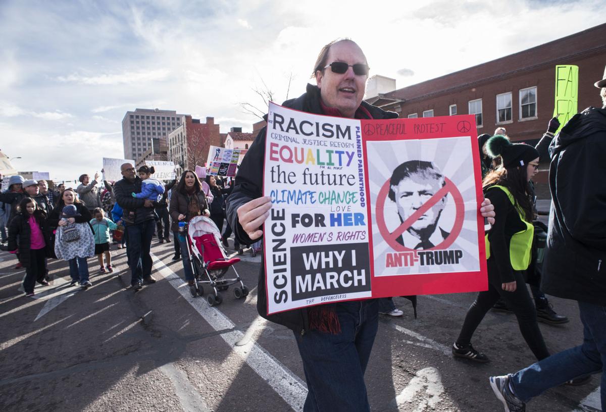 Protesters march down Nevada Avenue Saturday, Jan. 21, 2017, during the Colorado Springs Women's March in downtown Colorado Springs. The sister march of the Women's March on Washington, D.C., drew between 5,000 and 10,000 people. (The Gazette, Christian Murdock)