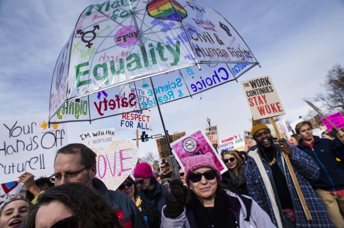 Protesters march down Tejon Street Saturday, Jan. 21, 2017, during the Colorado Springs Women's March in downtown Colorado Springs. The sister march of the Women's March on Washington, D.C., drew between 5,000 and 10,000 people. (The Gazette, Christian Murdock)