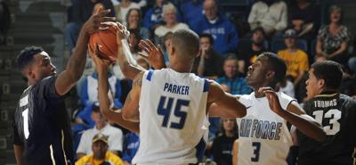 Colorado's Wesley Gordon, Air Force's Darrius Parker, Air Force's Justin Hammonds and Colorado's Dustin Thomas compete for the ball during the second half of a game.Colorado defeated Air Force 81-57 at Clune Arena on Saturday, November 30, 2013.(The Gaz...