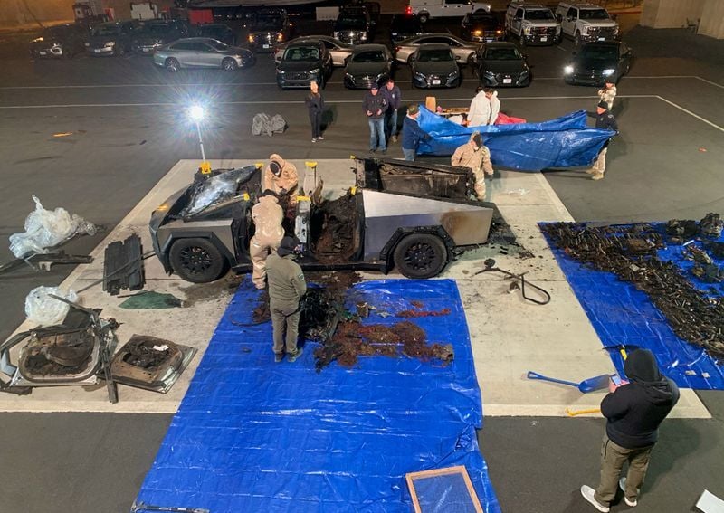 Investigators inspect the ⁤burned Tesla‌ Cybertruck, ‌which the police say⁢ was driven by Matthew Livelsberger