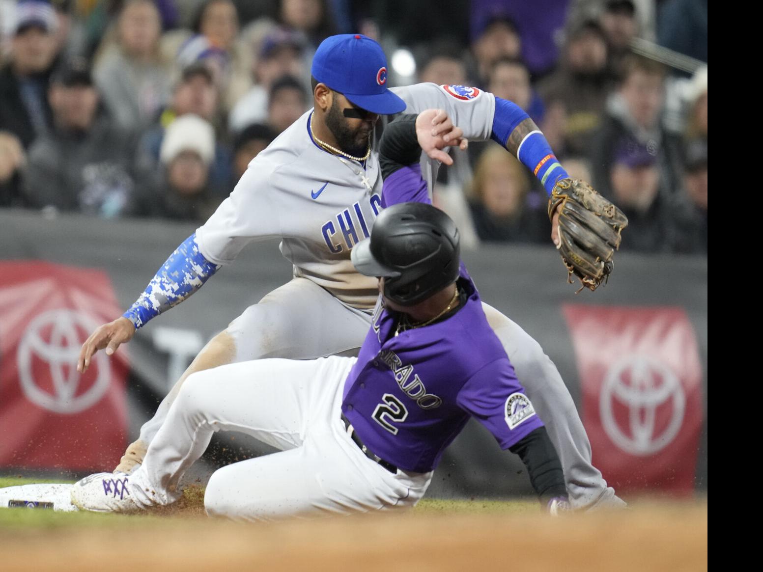 Randal Grichuk of the Colorado Rockies advances to third base in a