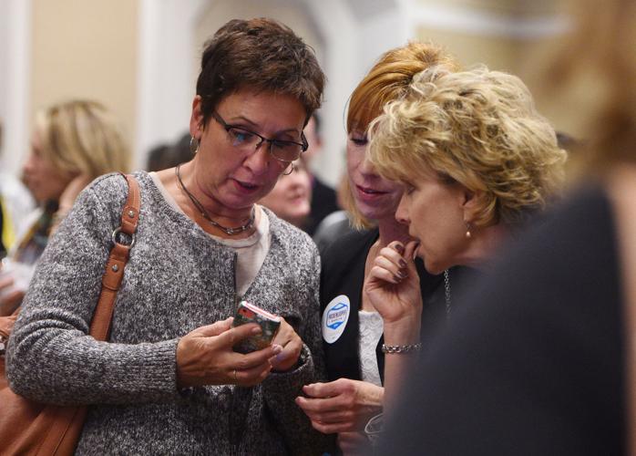 Colorado Dems Ingrid Fleming, Debbie Williams and Mindy Davis (left to right) look at results for the tight race for Colorado governor at the Colorado Democrats party at the Westin in Denver, Colorado on Tuesday, November 4, 2014. (The Gazette/Jerilee B...