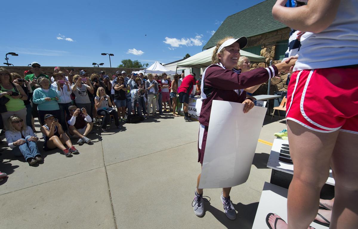 Cheyenne Mountain's Claire Dibble shakes hands with other No. 2 doubles teams while parents take pictures during the award ceremony Saturday, May 10, 2014, at the Colorado 4A girls state tennis championships finals at City Park in Pueblo. Dibble and her partner Tory Louis defeated St. Mary's Academy's Jisyasa Sharma and Rachel Hass 6-1, 3-6, 6-1 for the state title. (The Gazette, Christian Murdock)