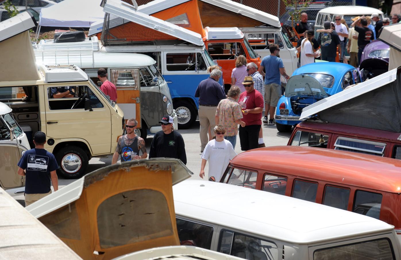 Spectators walk past the rows of VW Buses Saturday, July 27, 2013 during the Buses at the Brewery event outside Bristol Brewery and Ivywild School in Colorado Springs. More than 50 Volkswagon were on display at the annual event sponored by the Syndicate...