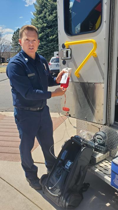 Lt. Joey Buttenweiser with Colorado Springs Fire Department on Friday, April 19, 2024, holds up a blood packet and describes how the bag, filled with whole blood (blood that has none of its components like red blood cells and plasma separated or removed...
