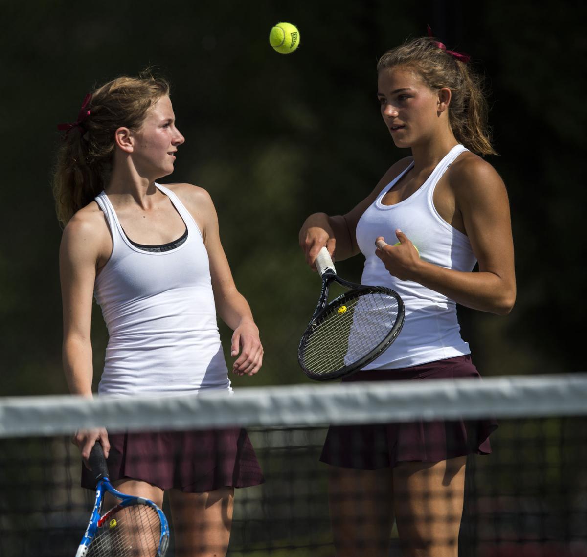 Cheyenne Mountain’s Casey Ahrendsen, right, tosses the balls to her partner Ally Arenson during No. 1 Doubles finals Saturday, May 13, 2017, at the 4A State Tennis Championships in Pueblo. The two won their fourth straight No. 1 Doubles title with a 6-1, 6-2 win over Valor Christian’s Tiffany Parobek and Lucie Hosse. (The Gazette, Christian Murdock)