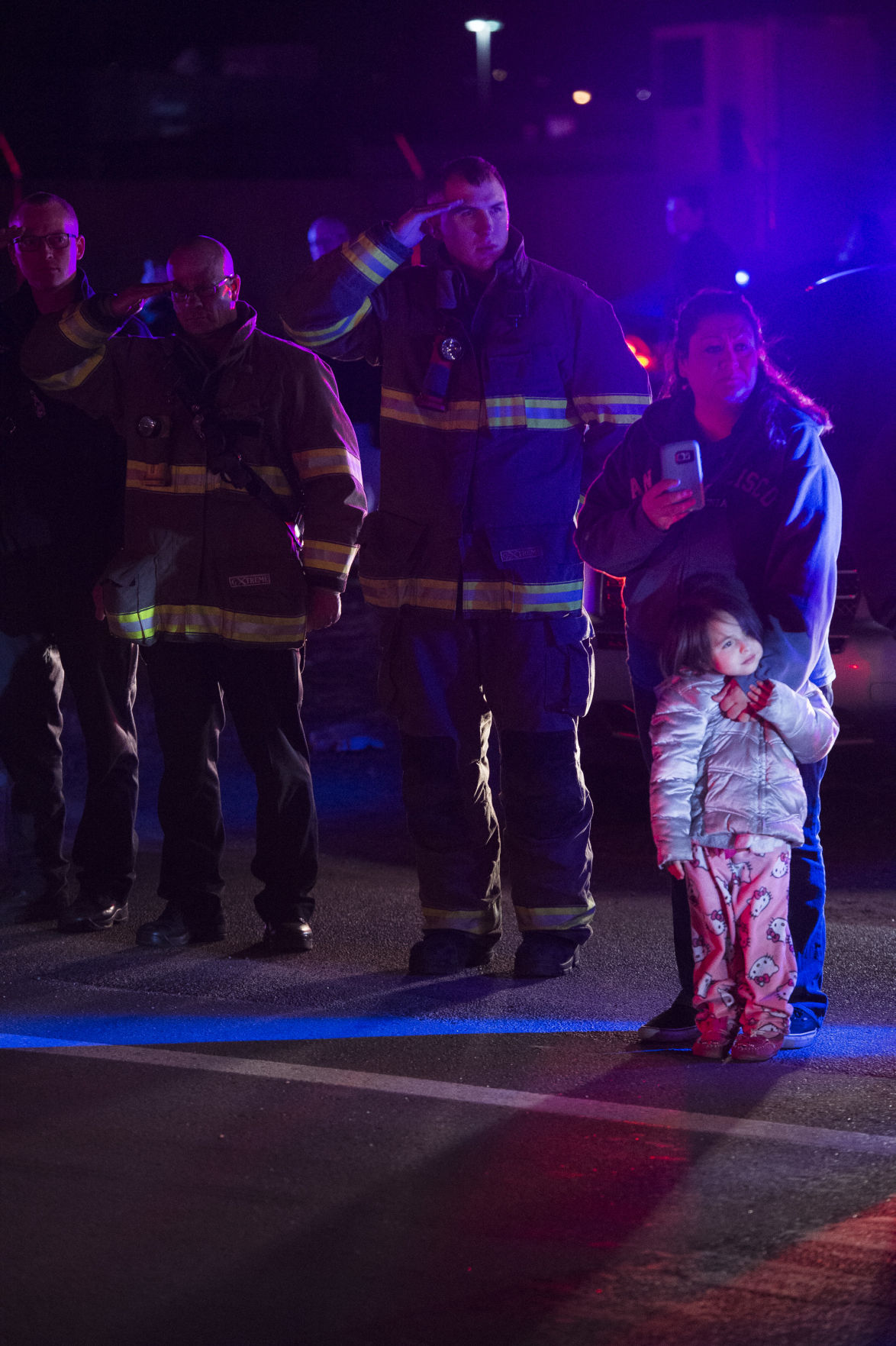 Firefighters salute the procession for El Paso County Sheriff's Deputy Micah Flick outside of the El Paso County Coroners Office Officers on Monday, February 5, 2018. Flick died in a shootout during a stolen car investigation. (Nadav Soroker, The Gazette)
