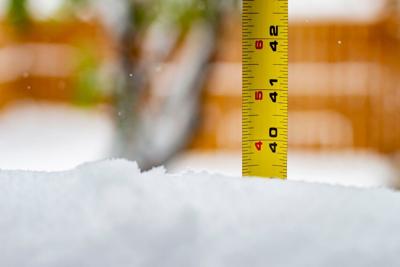 Measuring the snow depth with ruler 40 feet Photo Credit: Marvin Samuel Tolentino Pineda (iStock).