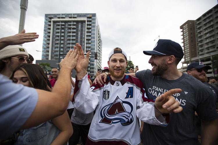 Colorado Avalanche defenseman Erik Johnson (6) and Colorado Avalanche left  wing Gabriel Landeskog (92) with the Stanley Cup during a rally outside the  City/County Building for the NHL hockey champions after a