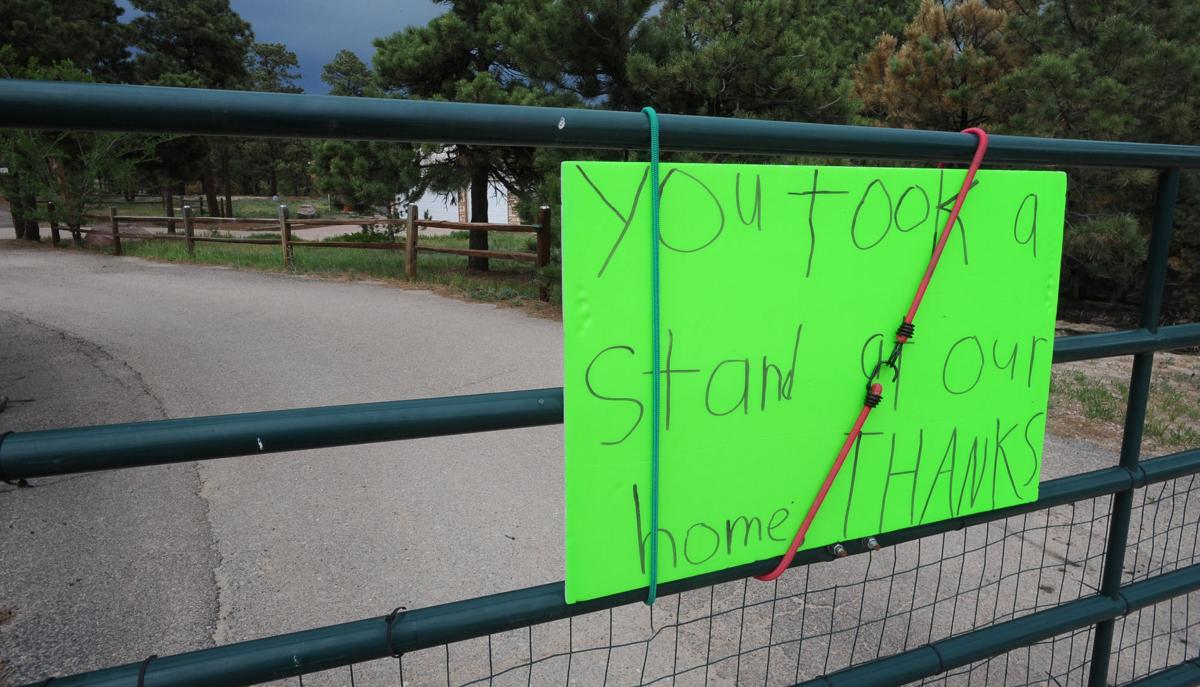On Hardin Rd, where many homes were lost in the Black Forest Fire, a child leaves a sign of support for the firefighters on Tuesday, June 18, 2013. Homeowners that are north of Burgess Rd. and east of Vollmer Rd. in the Black Forest burn area were able to return to their homes today on Tuesday, June 18, 2013.(Jerilee Bennett/The Gazette)