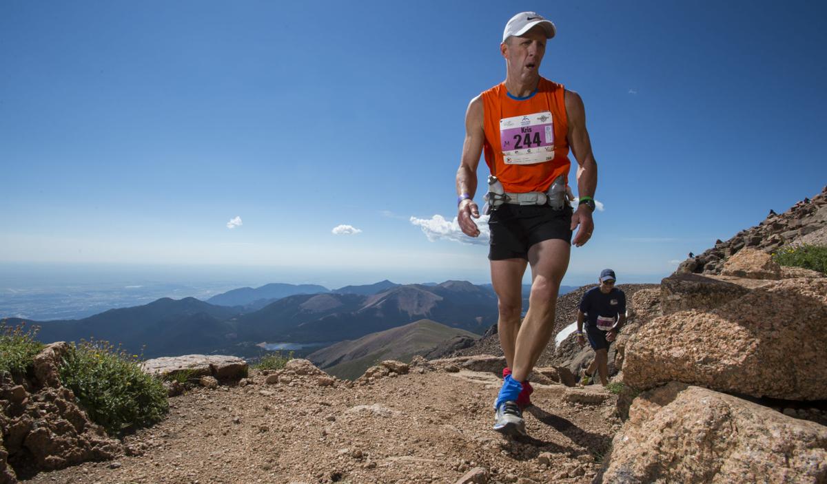 Kris Rutford of Lincoln, Neb., nears the finish of 2015 Pikes Peak Ascent Saturday, Aug. 15, 2015, on the top of 14,115-foot Pikes Peak. The 13.2-mile race begins in Manitou Springs, Colo., and follows Barr Trail to the top of the mountain. (AP Photo/The Gazette, Christian Murdock)