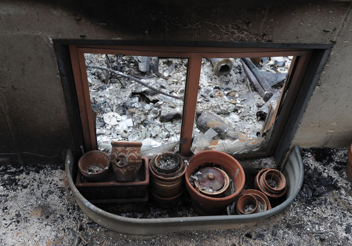 A charred window well looks into what used to be the basement of Black Forest resident, Dick Hoffman .Homeowners that are north of Burgess Rd. and east of Vollmer Rd. in the Black Forest burn area were able to return to their homes today on Tuesday, June 18, 2013.(Jerilee Bennett/The Gazette)