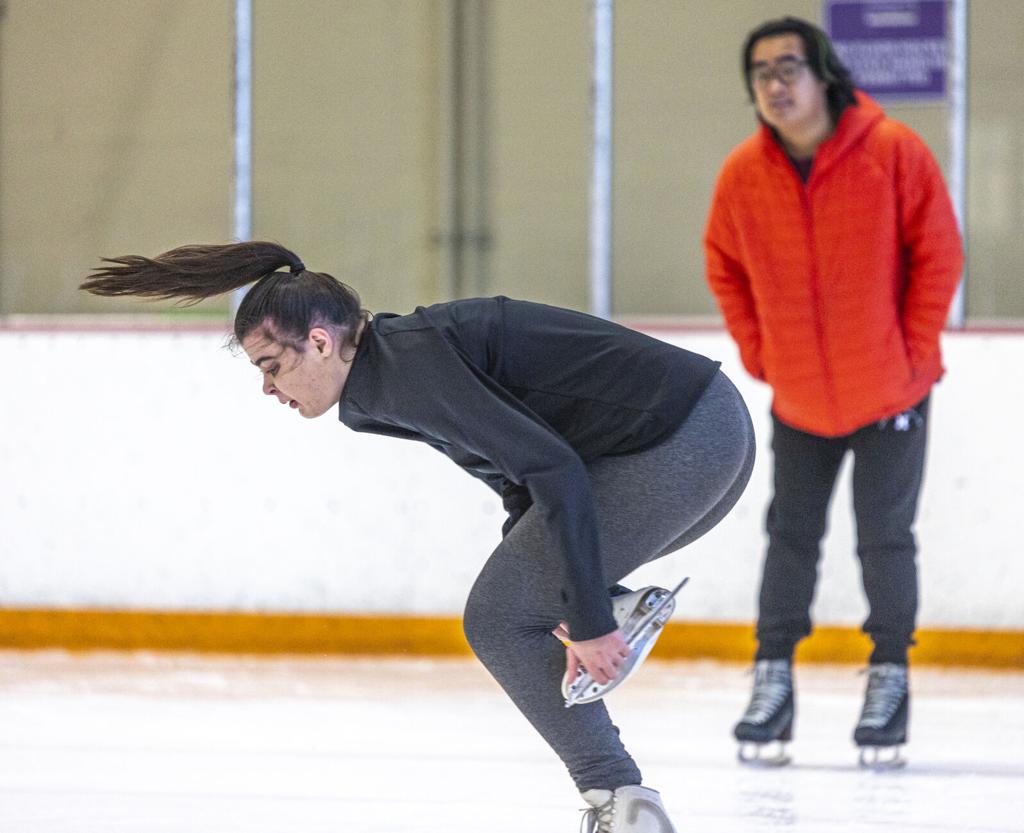 Premium Photo  Legs in figure skates are on the ice on the rink