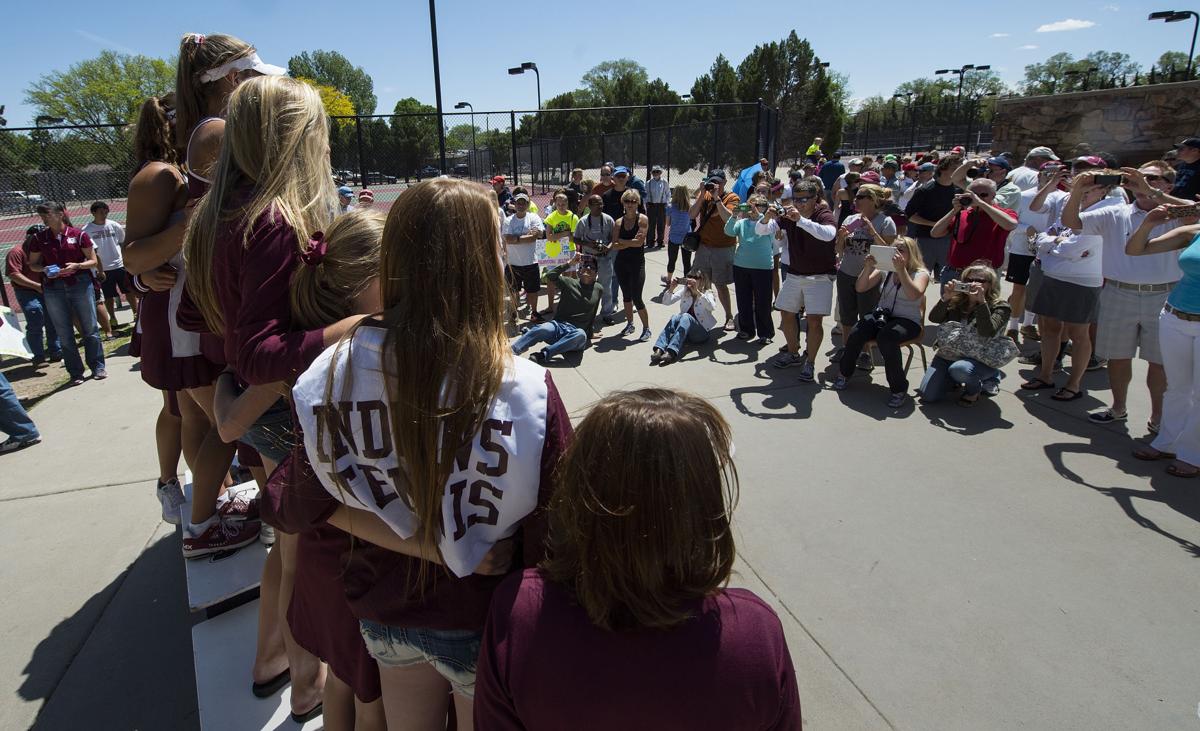 Parents take pictures of the Cheyenne Mountain girls tennis team and the 2014 State Champions trophy during the award ceremony Saturday, May 10, 2014, at the Colorado 4A girls state tennis championships finals at City Park in Pueblo. (The Gazette, Christian Murdock)
