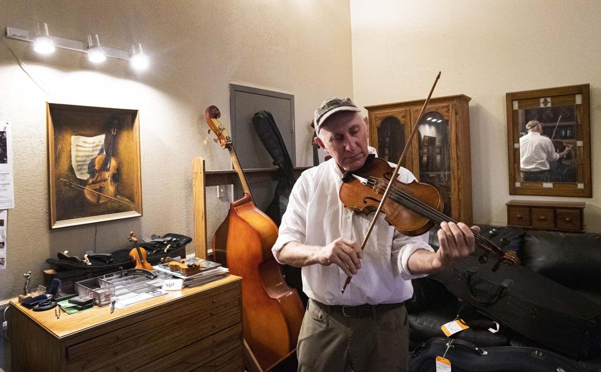 Hidden and in the heart of downtown, a violinmaker goes about his job