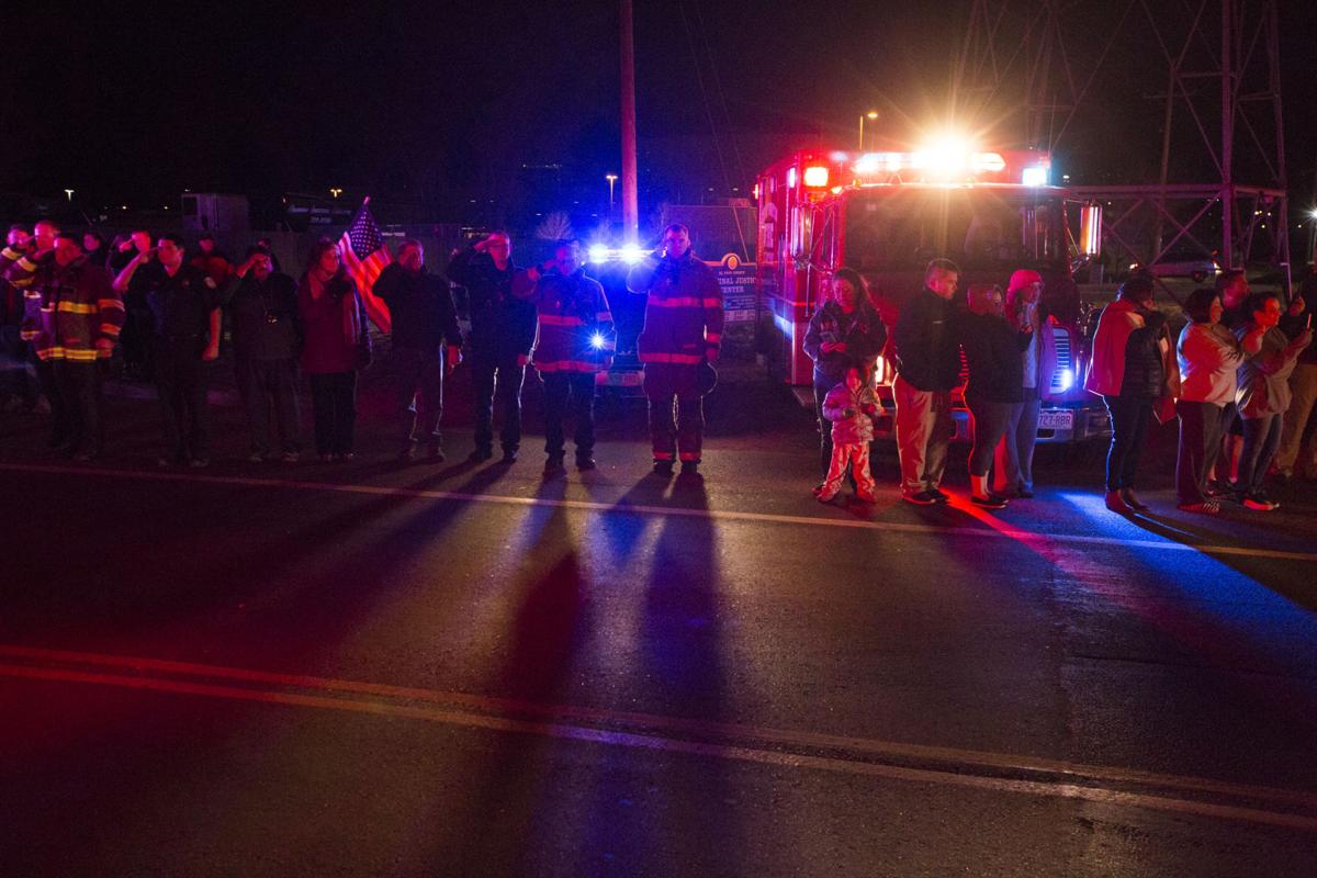 Firefighters salute the procession for El Paso County Sheriff's Deputy Micah Flick outside of the El Paso County Coroners Office Officers on Monday, February 5, 2018. Flick died in a shootout during a stolen car investigation. (Nadav Soroker, The Gazette)