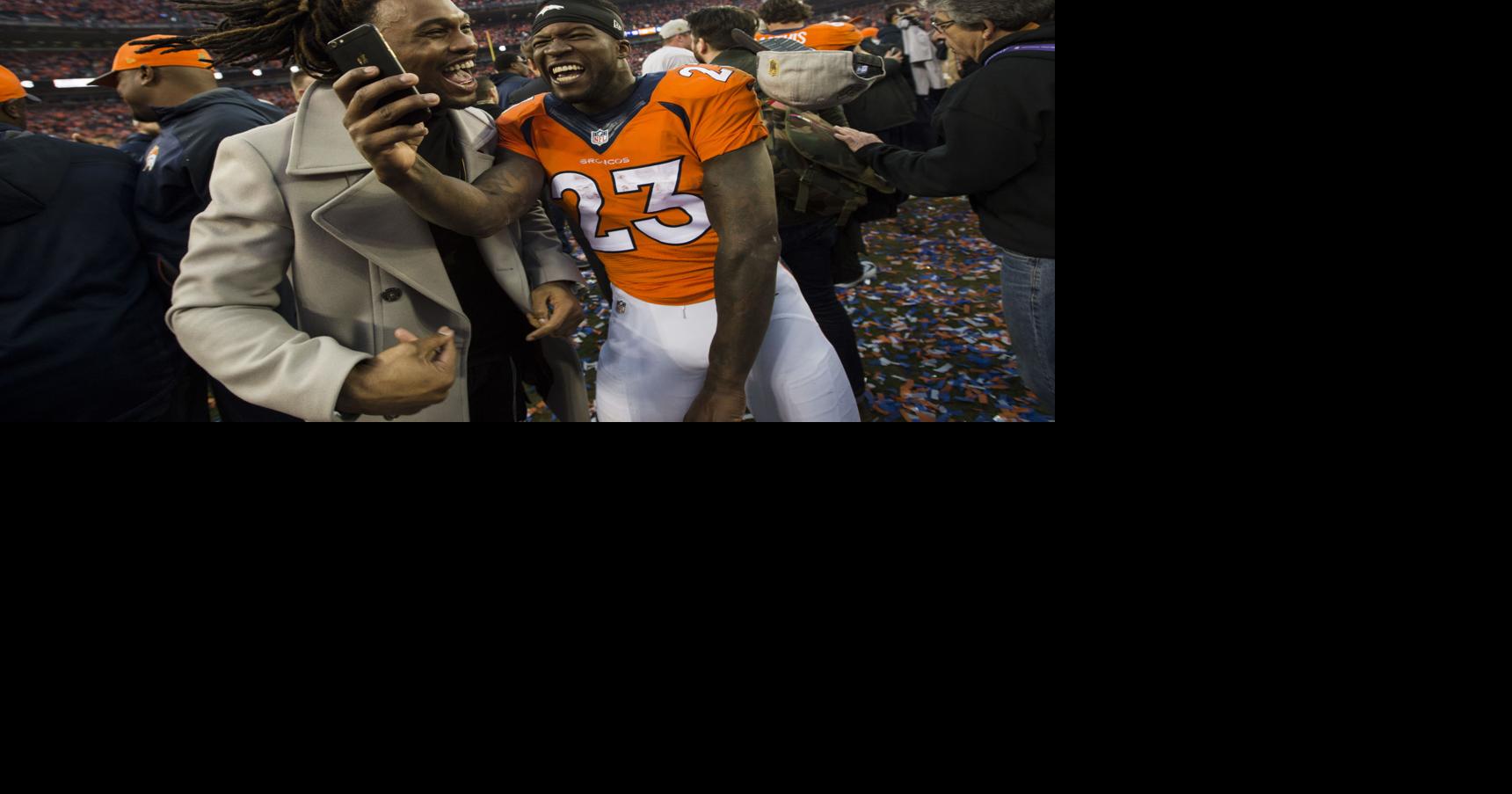 Broncos running back Ronnie Hillman joins the celebrate on the