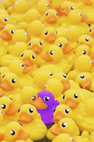 Unique Purple Toy Duck Among Many Yellow Ones. Standing Out From Crowd, Individuality And Difference