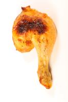 grilled chicken leg isolated on white background