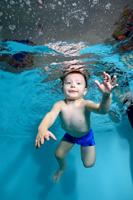 Baby Swims Underwater In The Pool With My Eyes Open. Portrait. Vertical Orientation.