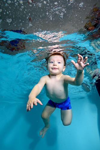 Baby Swims Underwater In The Pool With My Eyes Open. Portrait. Vertical Orientation.