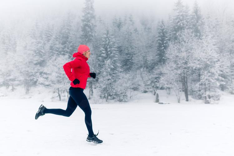 Trail Running Woman In Winter Mountains